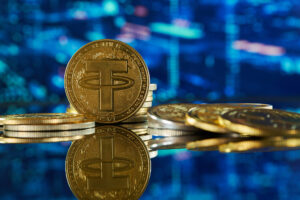 Gold Tether cryptocurrency on reflective surface